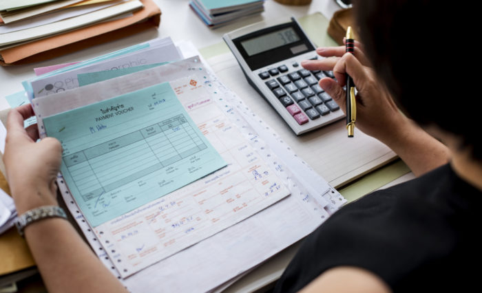 Asian woman working through paperwork