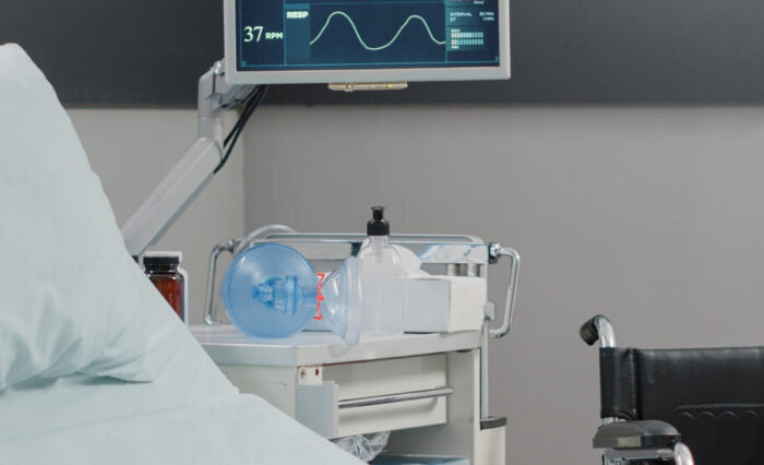 Empty hospital ward with heart rate monitor and bed for healthcare and recovery. Nobody in emergency room with medical equipment for intensive care patient. Reanimation room with tools